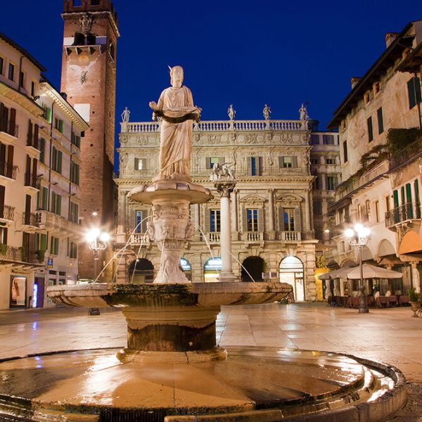 Verona---Fountain-on-Piazza-Erbe-in-dusk-and-Porta-Leona-and-Palazzo-Maffei-
